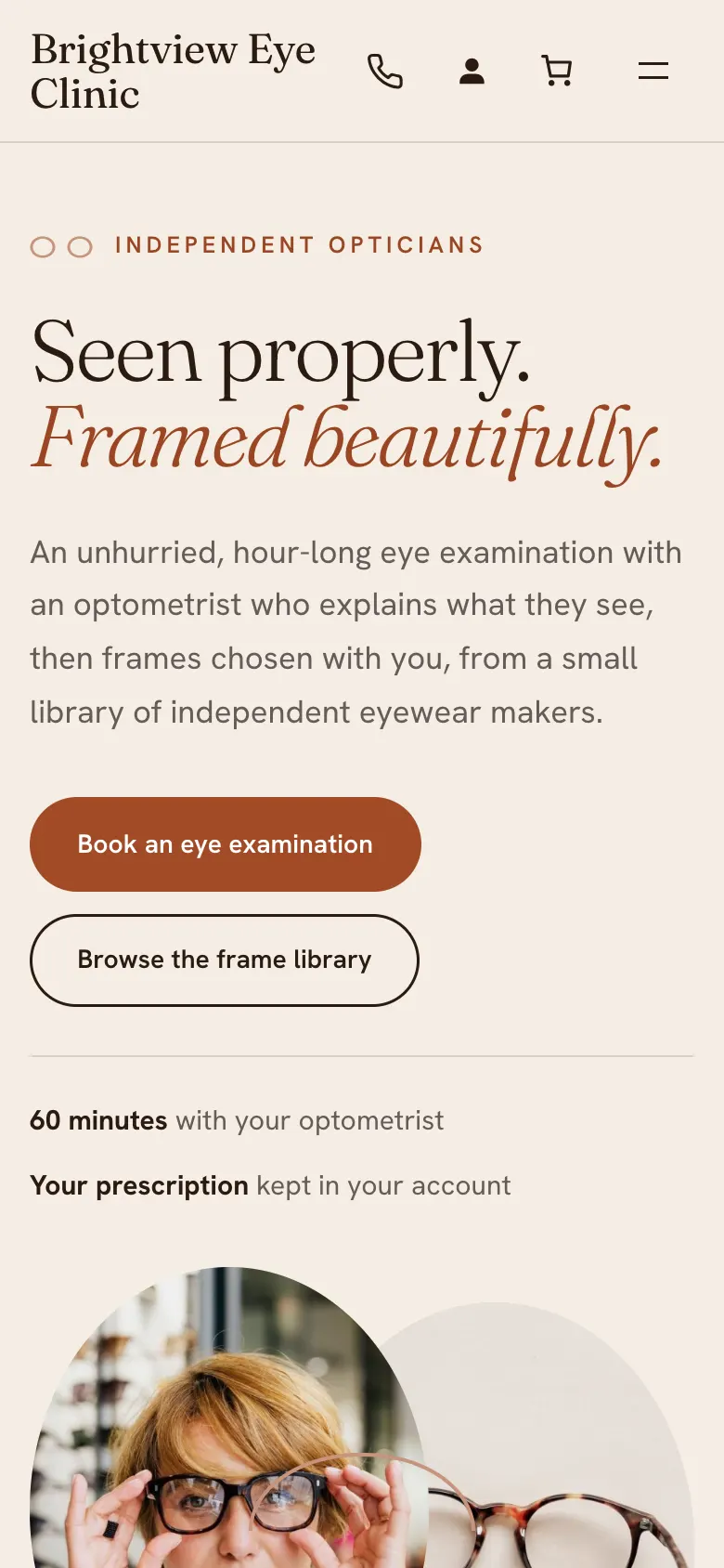 The Atelier home page on a phone, with the centred clinic name, the serif headline and a Book an eye examination button