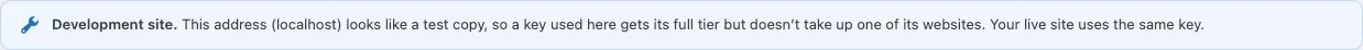 The Development site notice on the Licence tab: "This address (localhost) looks like a test copy, so a key used here gets its full tier but doesn't take up one of its websites. Your live site uses the same key."